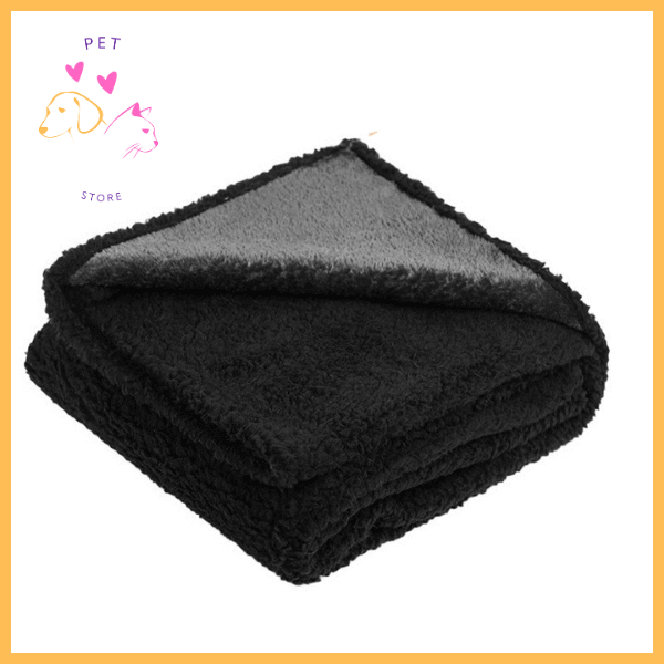 Folded black waterproof dog blanket with soft texture on white background