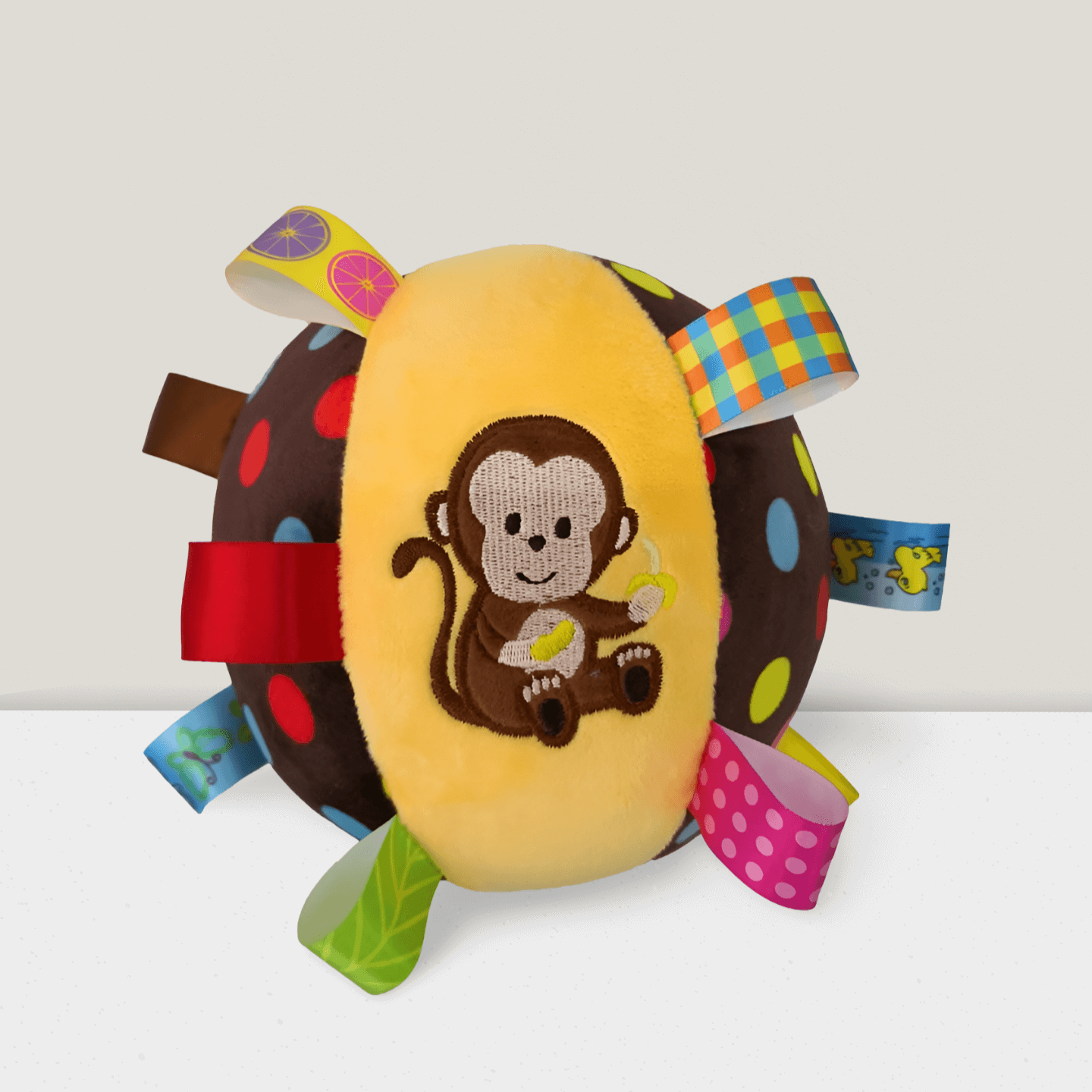 ChimeChew monkey plush dog toy ball with colorful tags and polka dot design