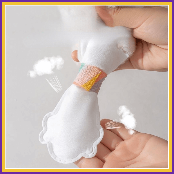 Hand squeezing DryPaws soft white material close-up, plush pet accessory texture