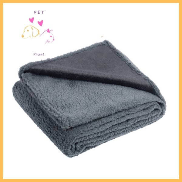 Folded gray waterproof dog blanket with soft fleece texture, pet store logo in corner
