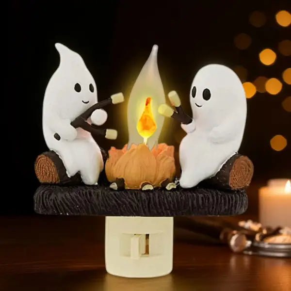 Ghost campfire night light with a warm glow, set against a dark cosy background with string lights and a candle