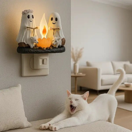 Ghost campfire night light glowing on a living room wall, with a cat resting on the sofa nearby