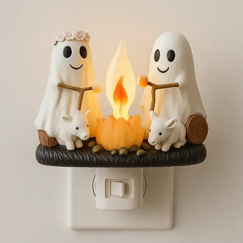 Ghost campfire night light plugged into a wall socket, with two resin ghosts roasting marshmallows over a glowing fire