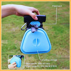 Hand holding blue foldable dog poop scooper with fixed port and folding storage design.
