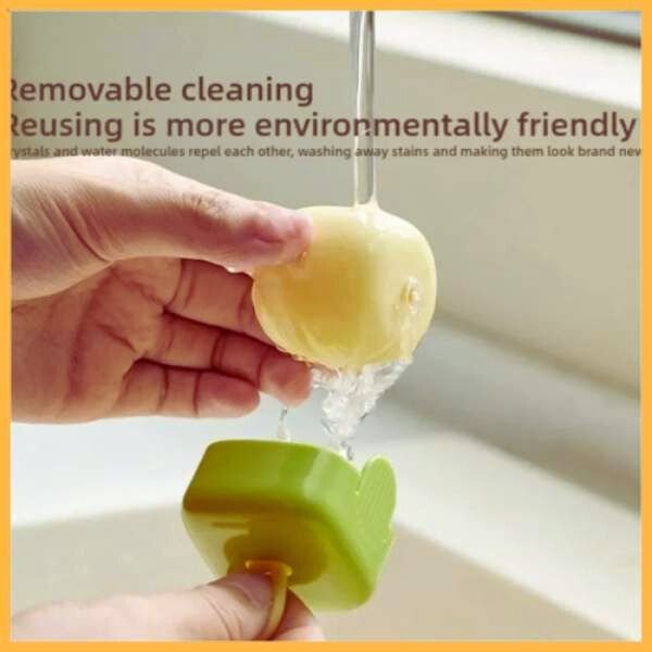 Hand rinsing reusable pet hair remover roller under running water in a sink
