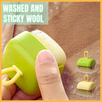 Reusable mini lint roller with green and yellow handle removing hair from fabric