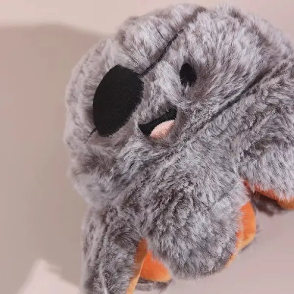 Close-up of the halloween dog toy's grey pirate octopus face with its black eye patch
