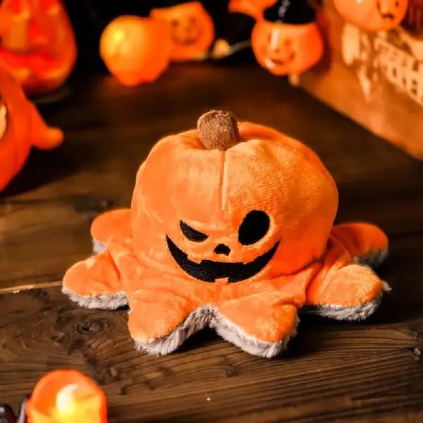 Halloween dog toy pumpkin side on a wooden surface, surrounded by other Halloween pumpkin decorations