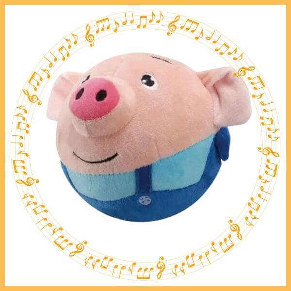 Interactive dog toy plush ball in pig design with blue overalls and music note border