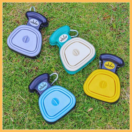 Multiple 'Grip' dog poop scoopers in various colors on grass