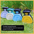 Colorful portable poop scoopers with hanging buckles for dogs on grass outdoors