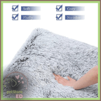 Hand touching soft fluffy gray orthopedic pet bed with cozy, no odor, washable features.