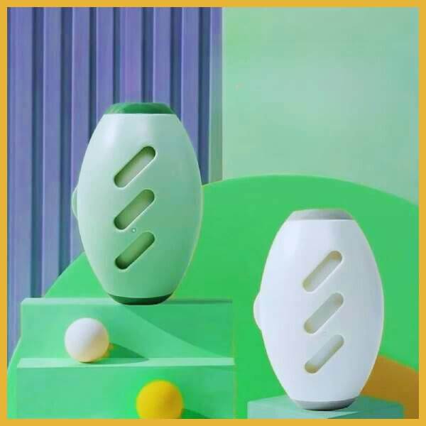 Reusable lint roller in green and white on colorful pet store display with balls