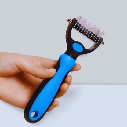 Hand showing size and grip of the Pet Store ED grooming tool.