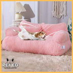 Small dog playing on pink plush pet bed in cozy living room with soft carpet
