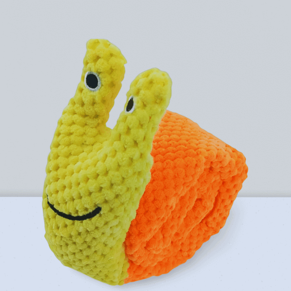 SnugBug Snail Yellow plush dog treat toy rolled into its compact snail shape
