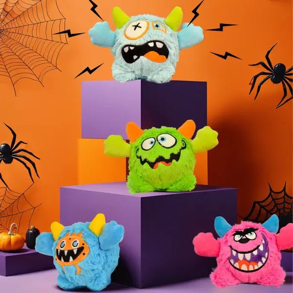 Four colour variants of the squeaky dog toy plush, blue, green, pink and light blue monster designs