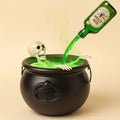 Witches cauldron with a skeleton and glowing green mist pouring from a potion bottle on a plain background